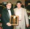 World Martial Arts Hall of Fame dinner. Kyoshi Sensei Edward E. Wilkes is showing his award to the son of one of the Employees of Power Wave Technology located in Irvine, California.