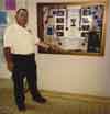 Kyoshi Sensei in front of display case showing his awards at the Lake Forest Sun and Sail Club in Lake Forest, California.